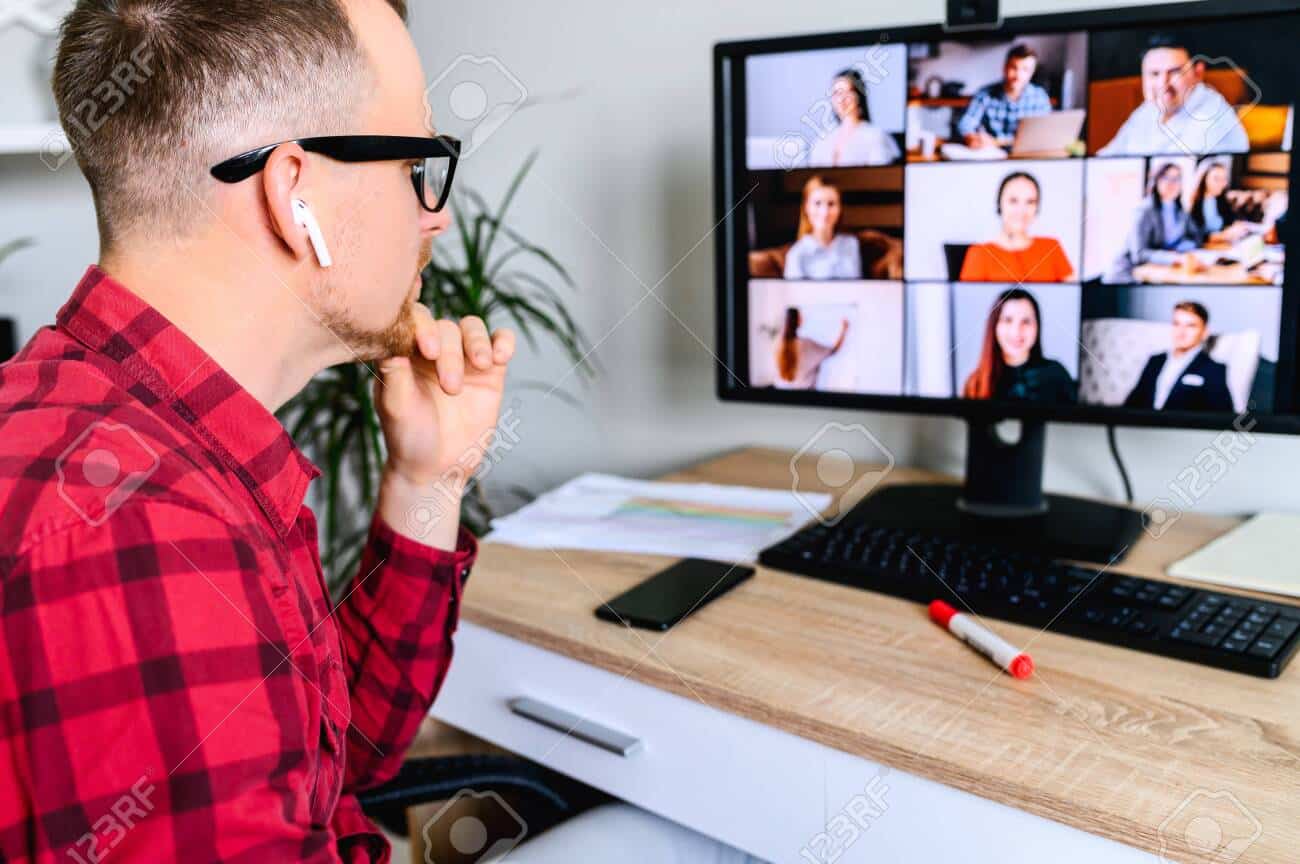 Young man connects via video call with coworkers